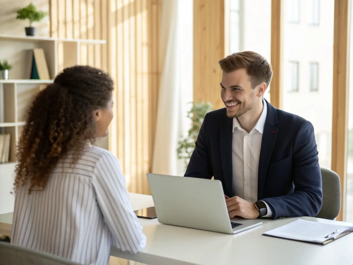 An image of a recruiter interviewing a candidate in a modern office setting, symbolizing LS & Partner's recruiting support services.
